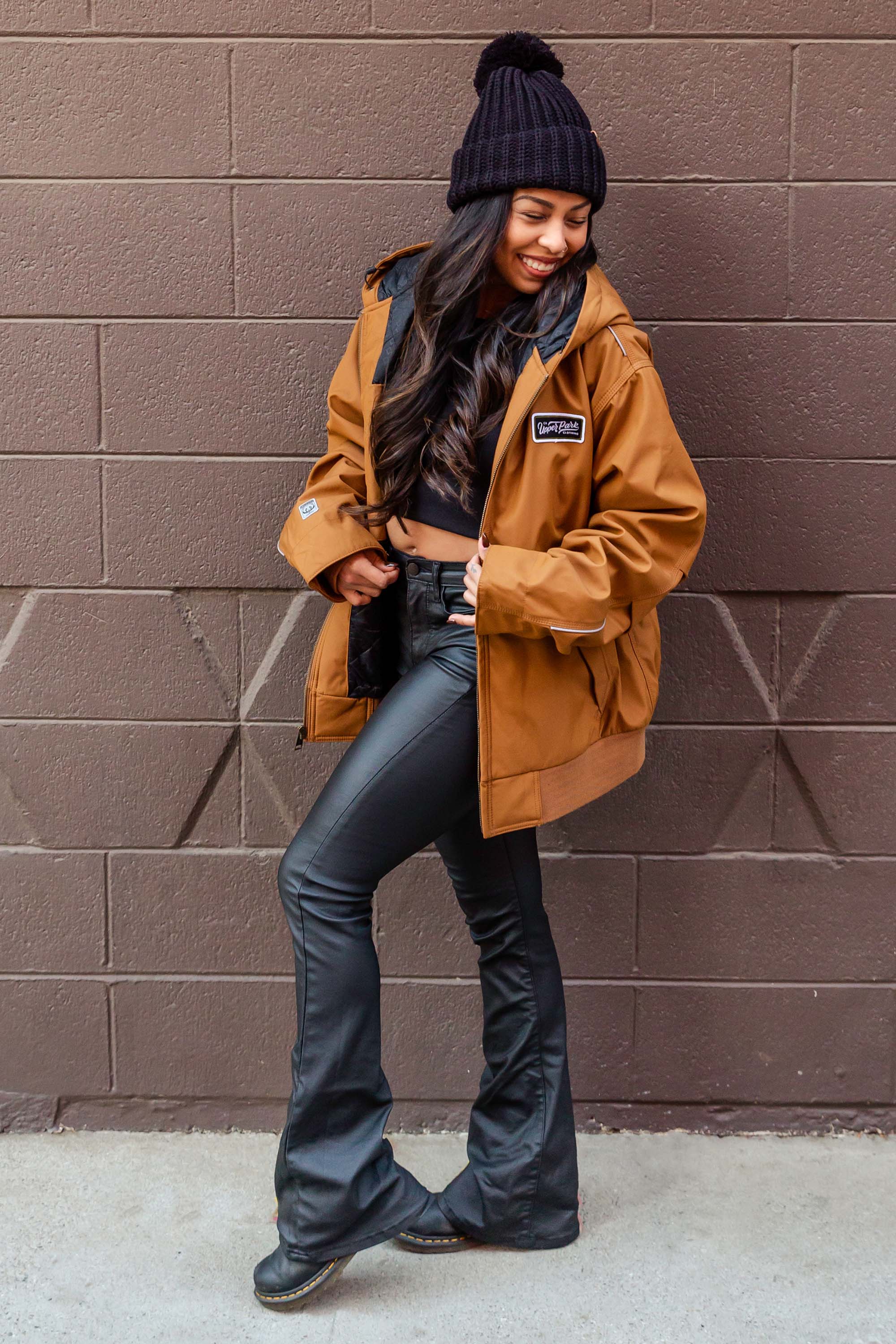 women standing in front of a blank wall in Downtown Chico wearing a workwear jacket from Upper Park Clothing