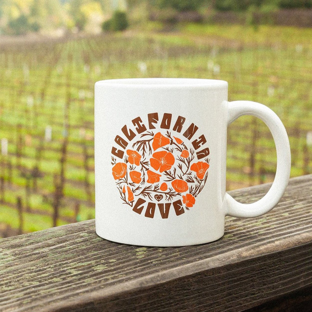 California Poppy Love Mug in front of vineyard - Upper Park Clothing - Chico, Ca