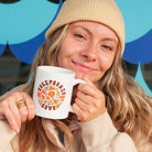 Woman holding a California Poppy Love Mug - Upper Park Clothing - Chico, Ca